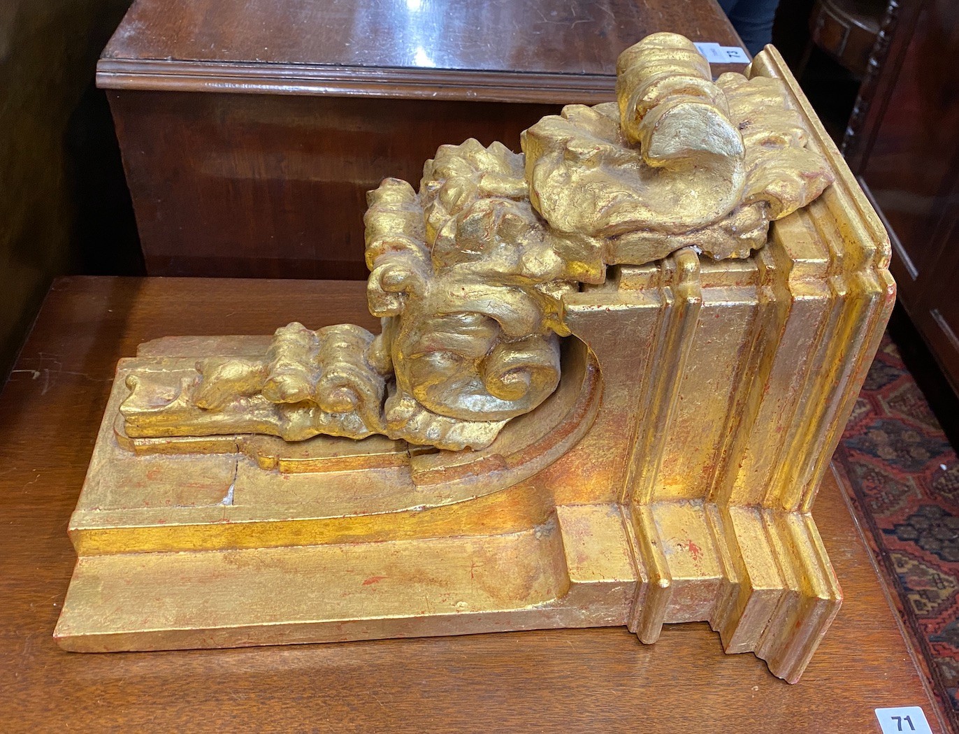 A George III style carved giltwood baroque style wall bracket, width 38cm, depth 30cm, height 48cm